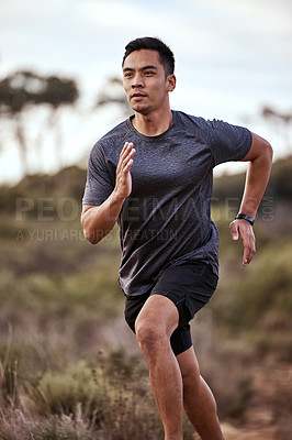 Buy stock photo Shot of a young man exercising in nature