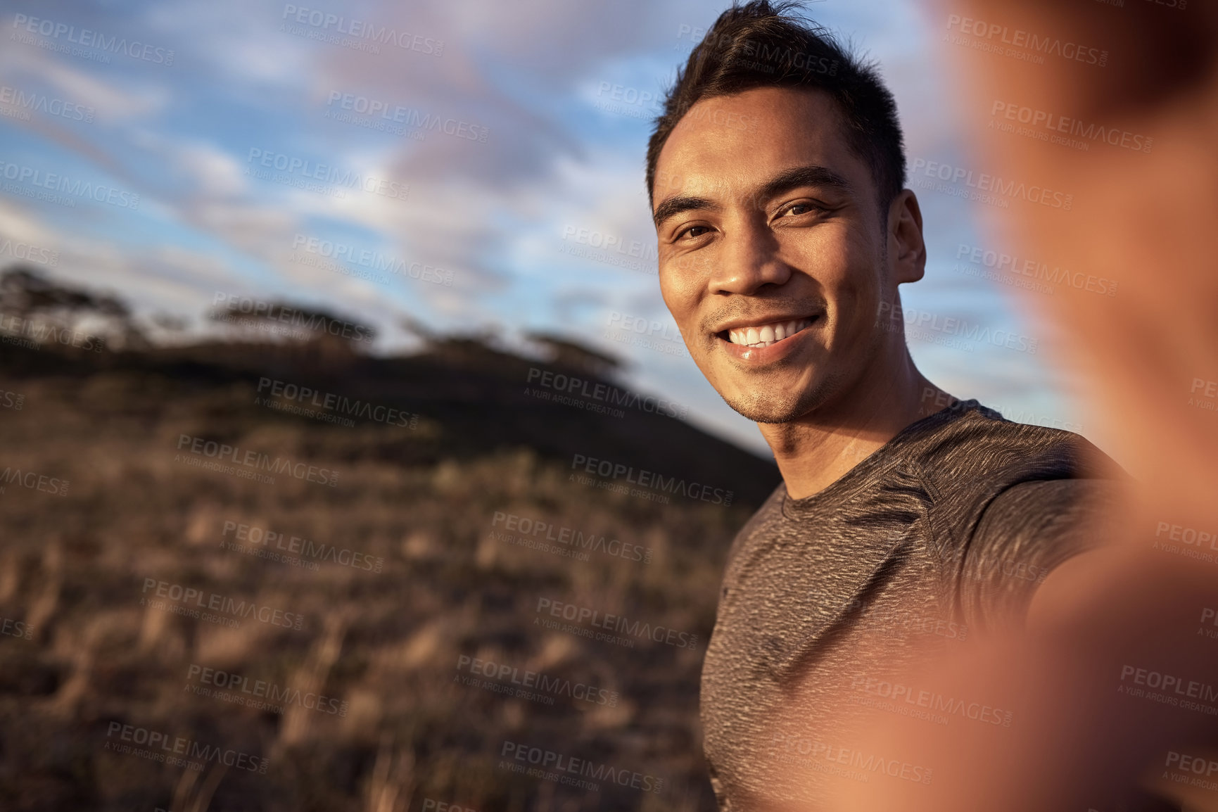 Buy stock photo Shot of a young man exercising in nature