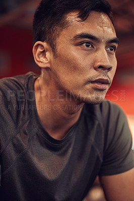 Buy stock photo Shot of a young man taking a break during a workout