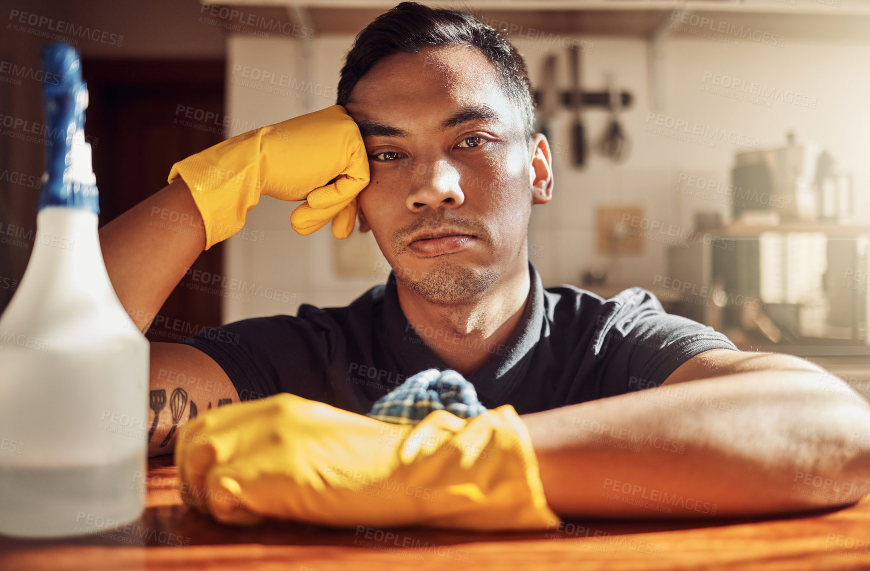 Buy stock photo Sad, man and cleaning with spray bottle and rubber gloves for safety, healthcare and housework. Bored, male janitor and burnout after spring clean with chemicals for hygiene and mental health