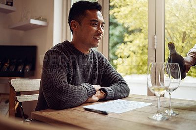 Buy stock photo Shot of a young man out wine tasting