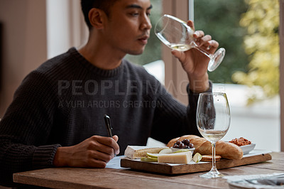 Buy stock photo Drinking, eating and restaurant with asian man food critic writing notes for review as customer. Cheese platter, glass and wine with consumer person in eatery for gourmet cuisine or meal assessment