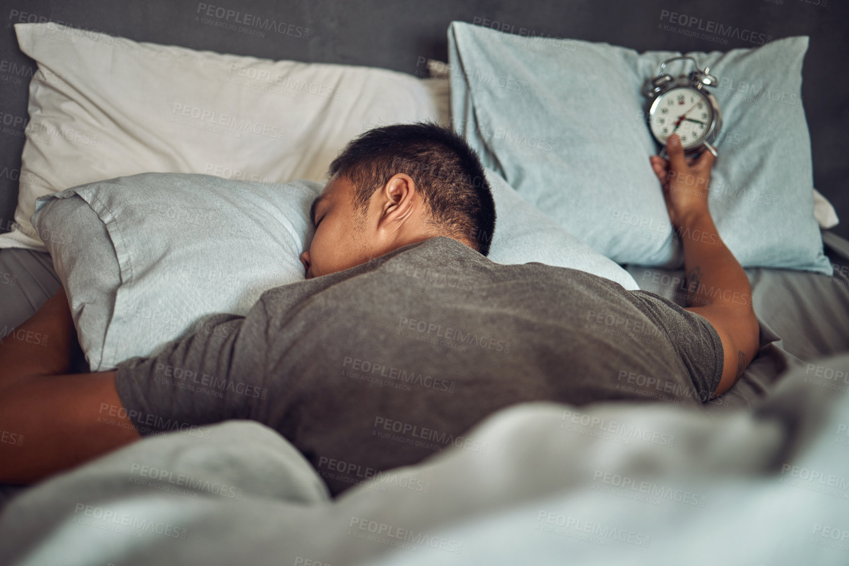 Buy stock photo Man, sleeping and bed with alarm clock or tired insomnia for bad time management, depression or dreaming. Male person, pillow and lazy snooze in home or overworked burnout, mental health or Monday