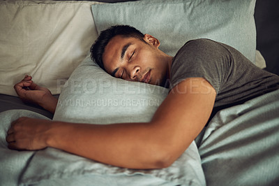 Buy stock photo Shot of a young man sleeping peacefully in bed at home