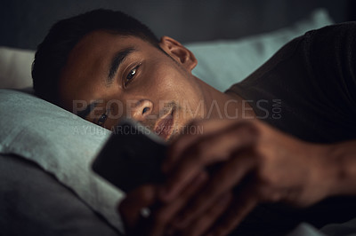 Buy stock photo Night, scroll and man in bed with phone surfing internet, social media post or texting with insomnia in home. Wake up, browse and male in dark bedroom with cellphone, mobile game and digital app.