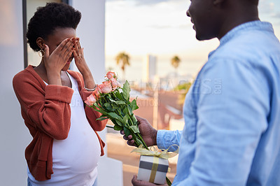 Buy stock photo Pregnant, wife and couple with man for surprise, flowers and gift box on balcony or bonding and relationship. Husband, romantic and giving push present or expecting woman, happy in family development