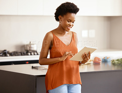 Buy stock photo Black woman, tablet and kitchen with smile for relax, weekend and counter with connect. Recipe, instruction or online tutorial for cooking in home with wireless technology, social media and browsing.