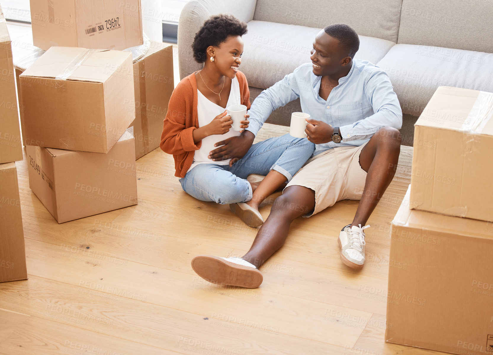 Buy stock photo Couple, new home and boxes with pregnancy in happy for moving, house and relocating on floor in living room. African, woman and man as excited in packing for apartment or property as young people
