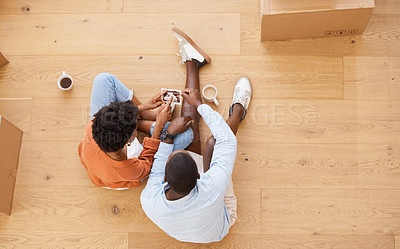 Buy stock photo Home, ultrasound and couple on floor together with coffee, moving boxes and planning future family development. Man, woman and pregnancy scan in new house with love, support and property from above