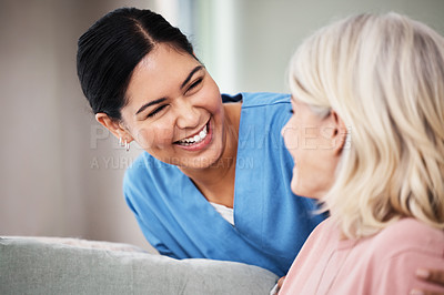 Buy stock photo Shot of a female nurse smiling while talking to her patient