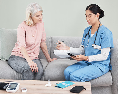 Buy stock photo Shot of a female nurse sitting with a clipboard while having a consultation with a patient