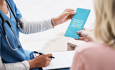 Buy stock photo Shot of a female nurse giving her patient a Covid-19 information pamphlet