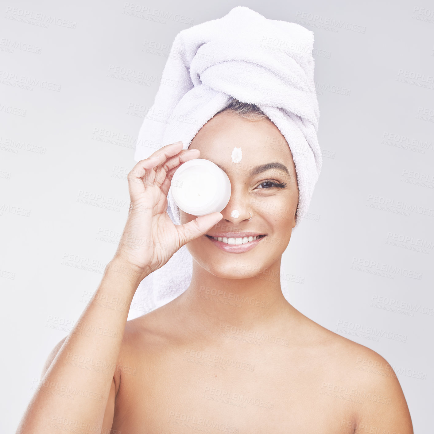 Buy stock photo Happy woman, portrait and skincare with container of cream for hygiene, beauty or facial treatment on a gray studio background. Face of young female person or model with smile for anti aging ointment