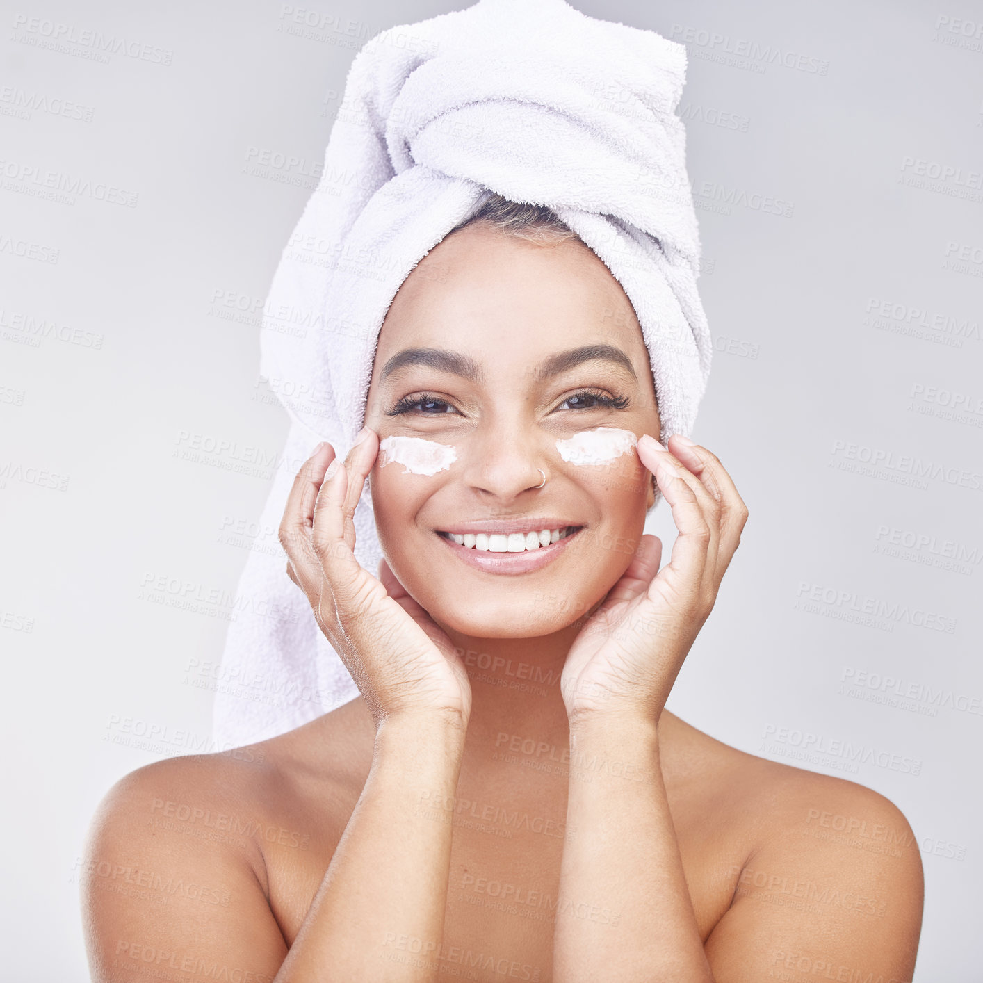 Buy stock photo Happy woman, portrait and skincare with cream for facial treatment, hygiene or beauty on a gray studio background. Face of young female person or model with smile, anti aging ointment or healthy skin