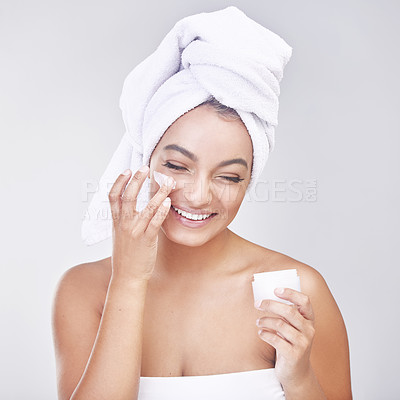 Buy stock photo Happy woman, skincare and container with cream or ointment for hygiene or beauty on a gray studio background. Face of female person or model with smile for lotion, anti aging or facial treatment