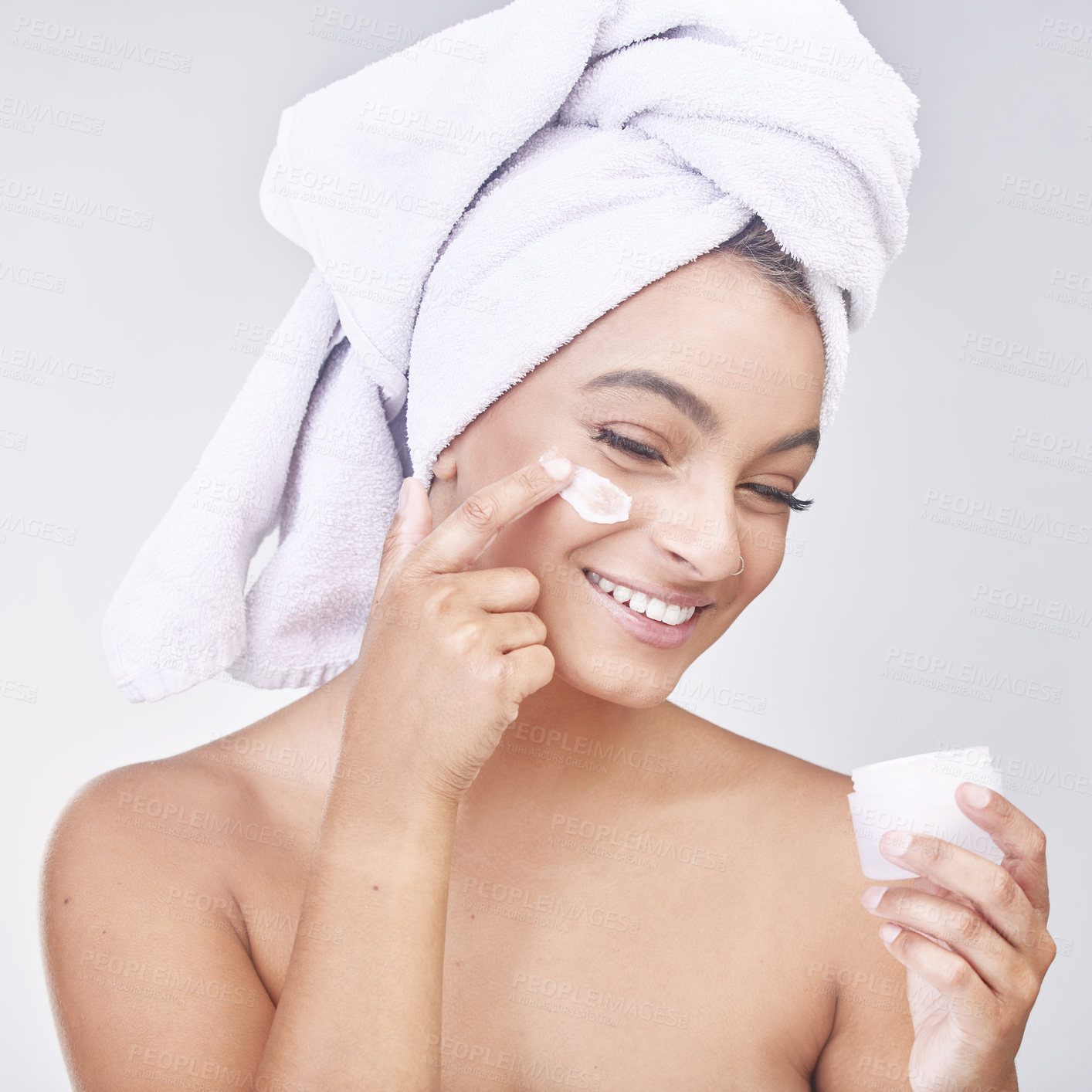 Buy stock photo Happy woman, skincare and container with lotion or cream for hygiene or beauty on a gray studio background. Face of female person or model with smile for ointment, anti aging or facial treatment