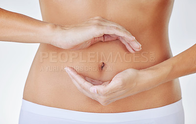 Buy stock photo Hands frame, stomach and woman in studio showing gut health, wellness and weight loss. Digestion, female person and hand by abdomen with circle for healthy body care and fitness with white background