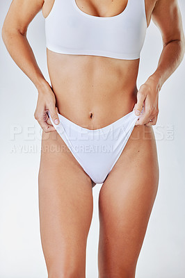 Buy stock photo Shot of a woman posing in her underwear against a studio background
