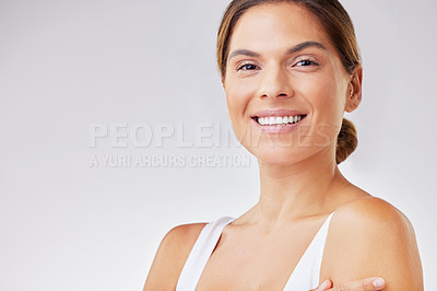 Buy stock photo Shot of a young woman admiring her complexion against a studio background