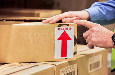 Buy stock photo Arrow sign, hands or man with boxes, warehouse or cardboard package with information, delivery or cargo. Zoom, male person or employee with a parcel, sticker or storage with packaging or shipping