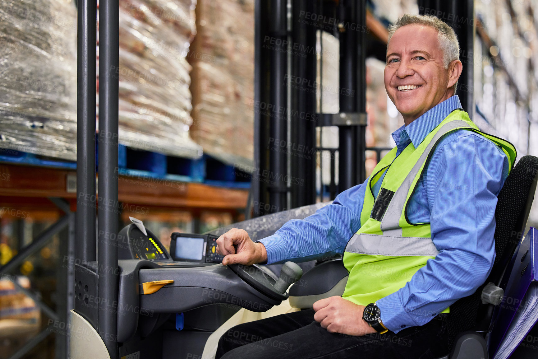 Buy stock photo Shot of a mature man working on a forklift  in a warehouse