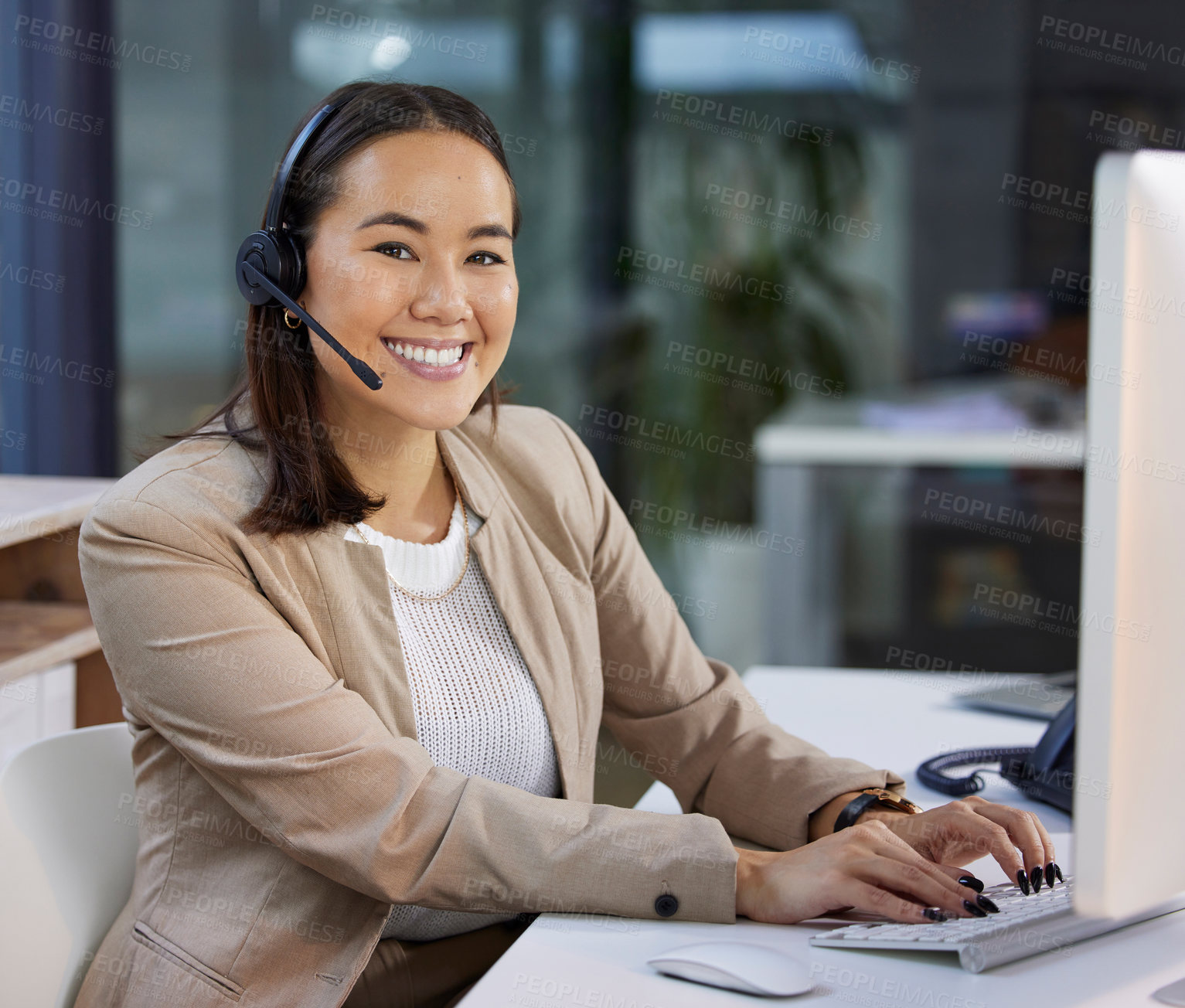 Buy stock photo Portrait of a young woman using a headset and computer in a modern office