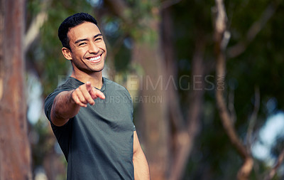 Buy stock photo Portrait of a sporty young man pointing outdoors