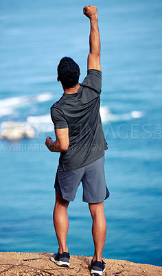 Buy stock photo Man, hiking and mountain celebration at cliff with fist for exercise victory or outdoor view, back or workout. Male person, trekking and health goals at ocean or explore Australia, journey or travel