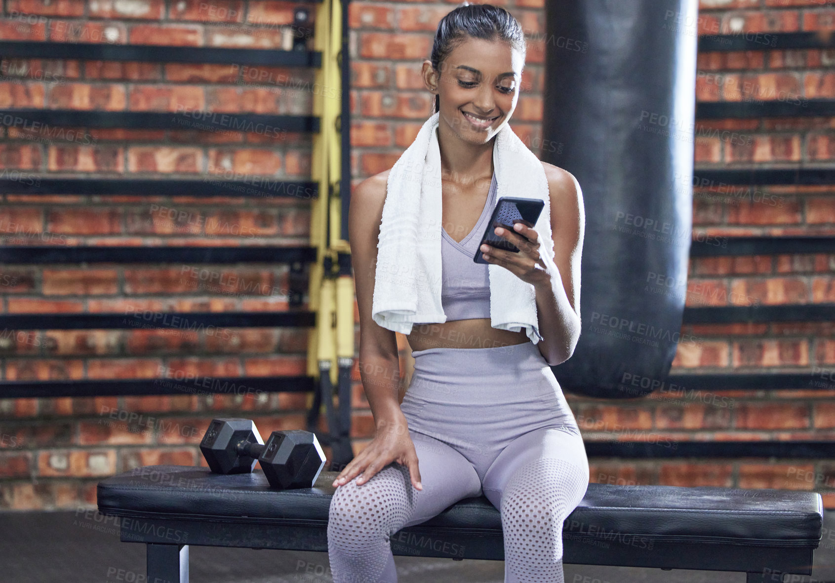 Buy stock photo Happy woman, fitness and break with phone at gym for browsing or online search on workout or exercise. Female person with smile on mobile smartphone for training tips, news or app at health club