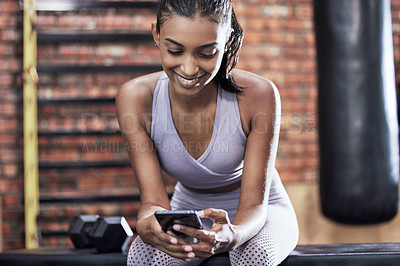 Buy stock photo Happy woman, fitness and browsing with phone at gym for online search on workout or exercise. Young female person with smile on mobile smartphone for training tips, news or app at indoor health club
