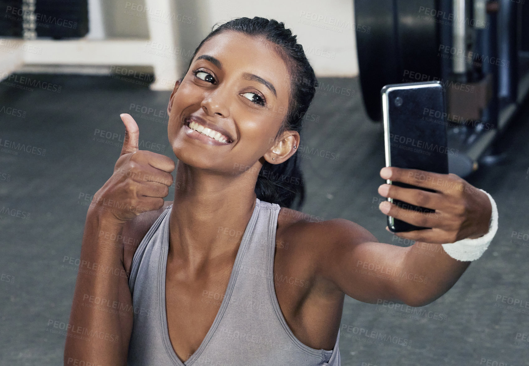 Buy stock photo Woman, thumbs up and selfie on phone in gym for social media post or wellness blog in training. Happy, active and female person with mobile for sign of success workout or fitness session for health