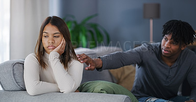 Buy stock photo Shot of a young couple having an argument at home