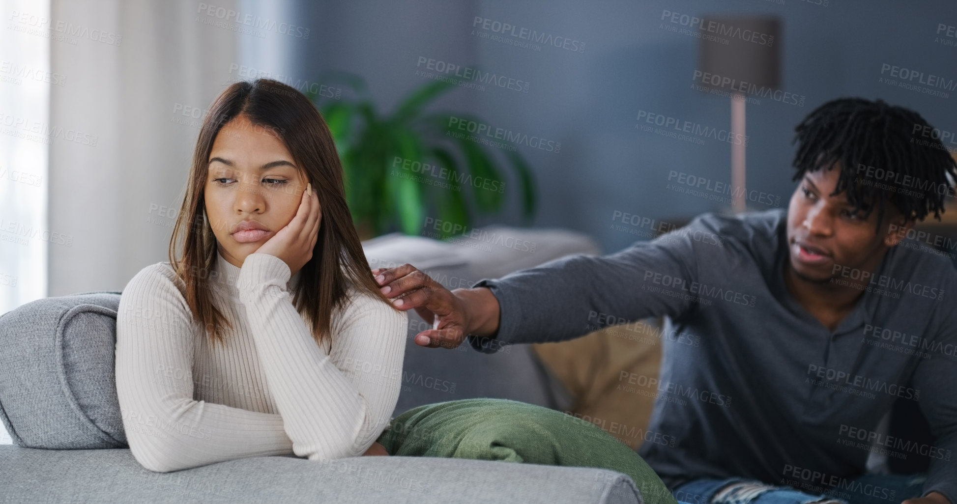 Buy stock photo Shot of a young couple having an argument at home