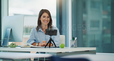 Buy stock photo Shot of a beautiful professor sitting while using her cellphone at her desk