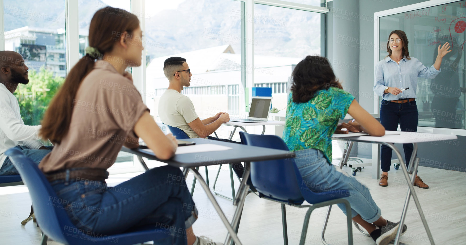 Buy stock photo Shot of students in classroom having a discussion with the professor at university