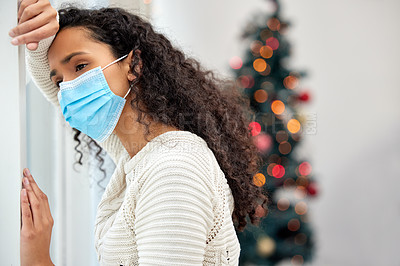 Buy stock photo Shot of a young woman spending Christmas at home alone