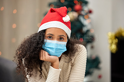Buy stock photo Christmas, medical mask and portrait of woman in living room for pandemic, lockdown or self isolation in home. Xmas, quarantine and sad person with santa hat for holidays, festive season or tradition