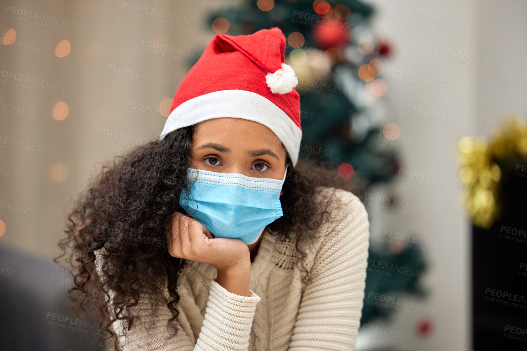 Buy stock photo Christmas, medical mask and portrait of woman in living room for pandemic, lockdown or self isolation in home. Xmas, quarantine and sad person with santa hat for holidays, festive season or tradition
