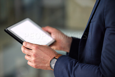 Buy stock photo Cropped shot of an unrecognizable man using a digital tablet at work