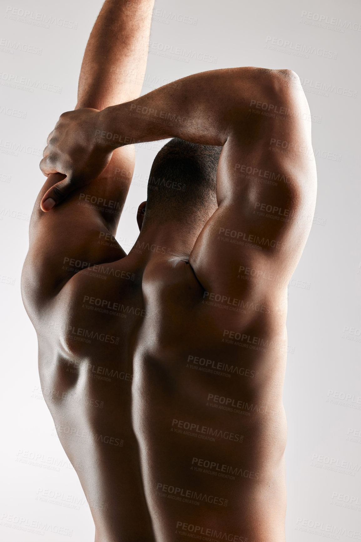 Buy stock photo Studio shot of a unrecognizable male flexing his back muscles against a grey background