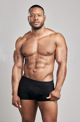 Buy stock photo Black man, muscle and portrait in studio with underwear for health, fitness and confidence for flexing. Wellness, strength and bodybuilding competition in Canada with pride for body with training