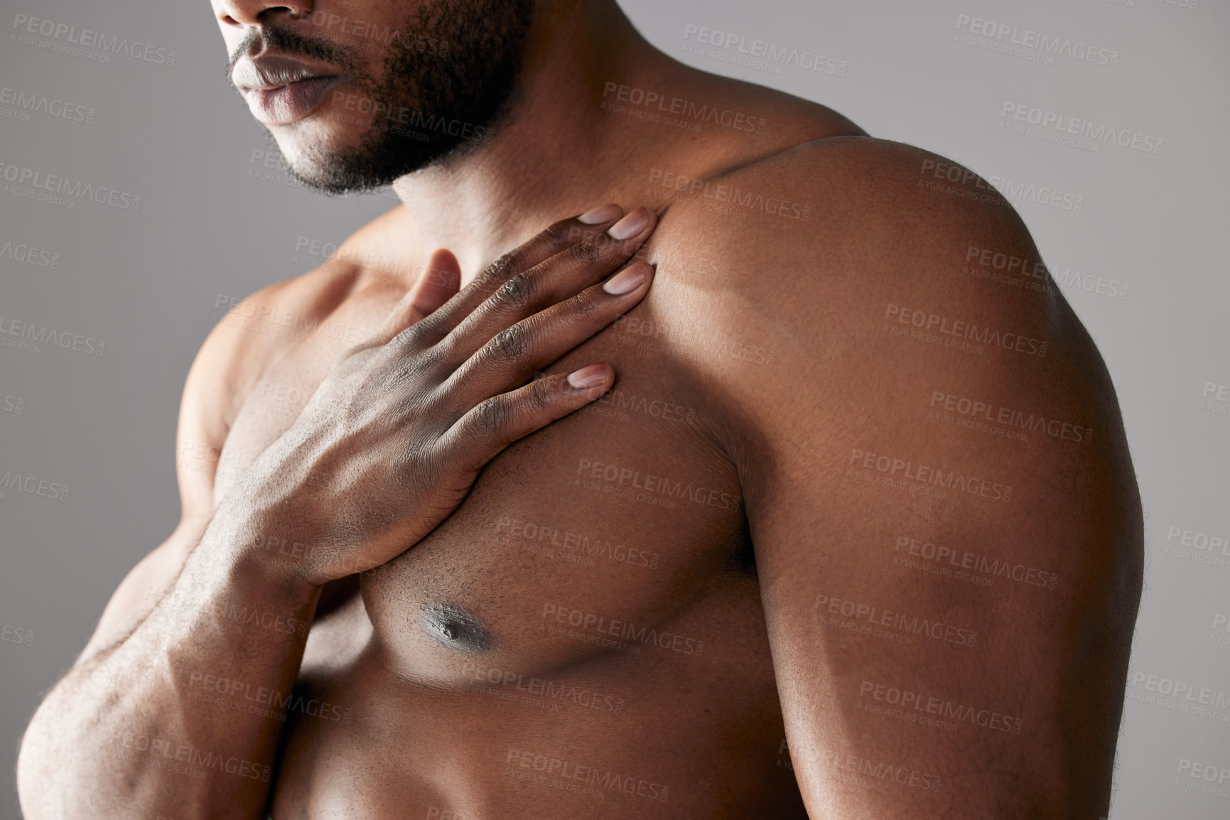 Buy stock photo Hand, chest and black man in studio with muscle, topless and healthy body on gray background. Male bodybuilder, fitness and strength or health for strong athlete, performance and masculine skincare