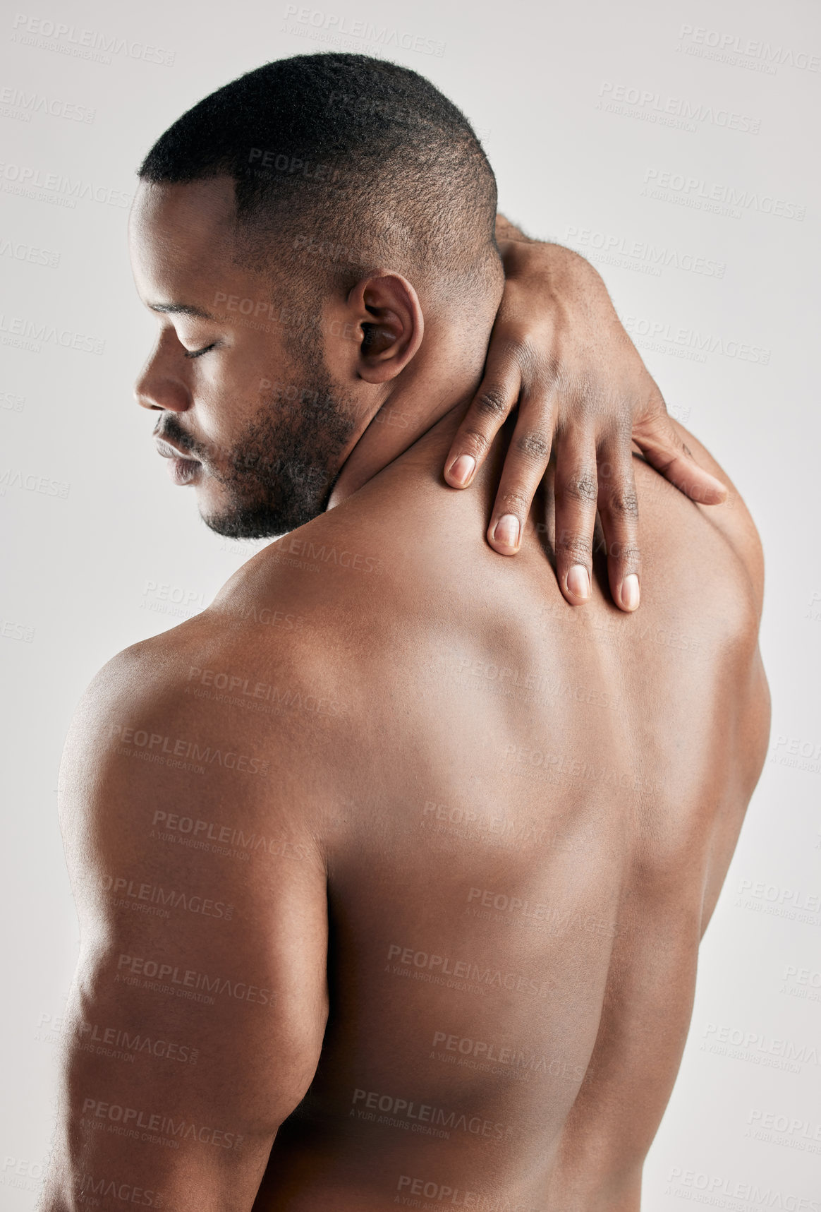 Buy stock photo Back, stretching and bodybuilder in studio with body health, pain or fitness and exercise for gym. Man, sports and white background with muscle of model for training, hand for anatomy or growth