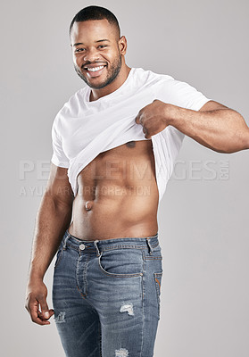 Buy stock photo Jeans, muscle and black man with portrait, smile and tshirt for abs, fitness and wellness in studio. Workout, healthy and African person with fashion, clothes and model, strong and white background