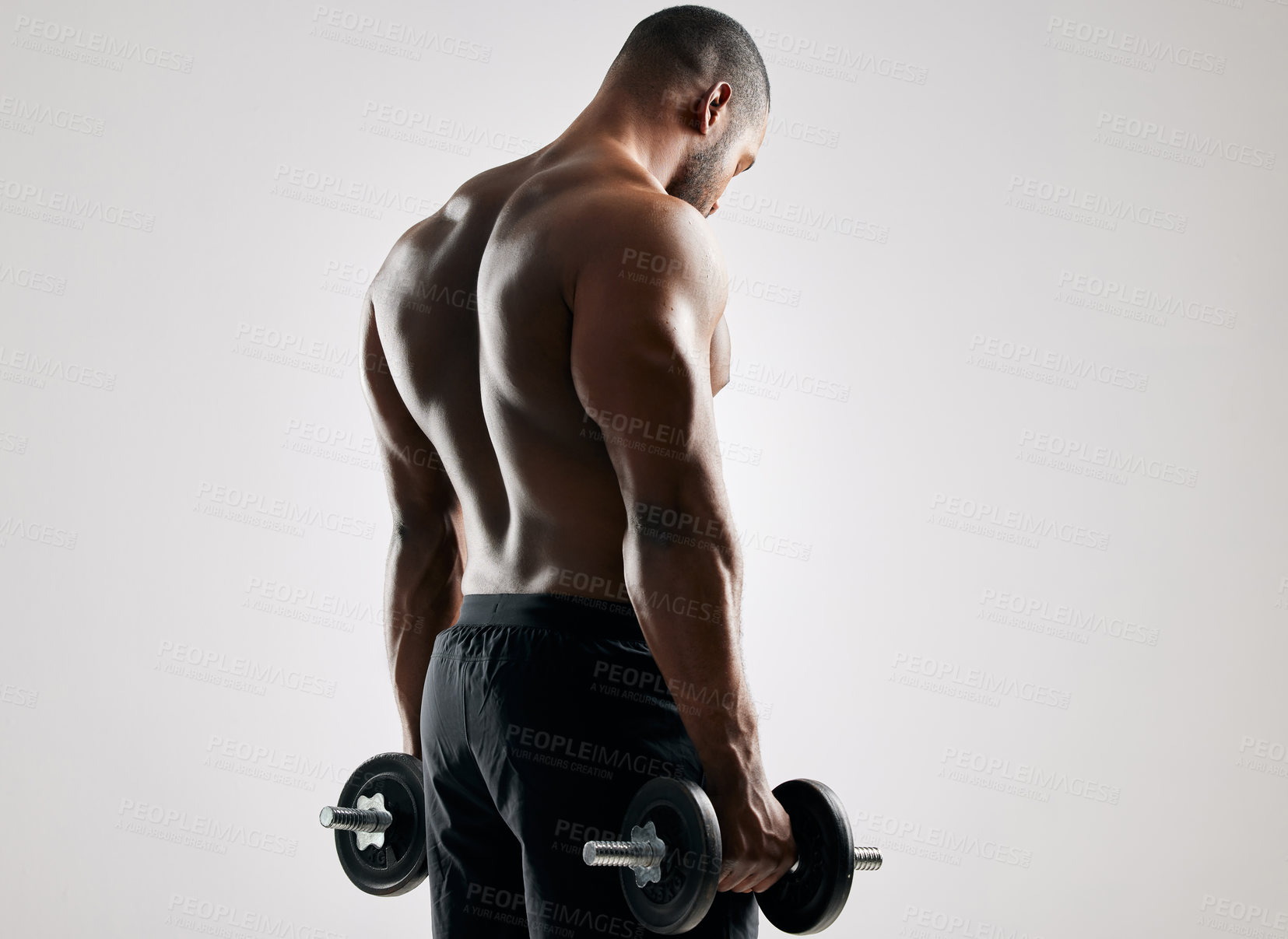 Buy stock photo Man, studio and workout with weights to exercise for healthy living or fitness and committed on white background. Gym equipment, back and dumbbells for muscle or training with wellbeing and self care