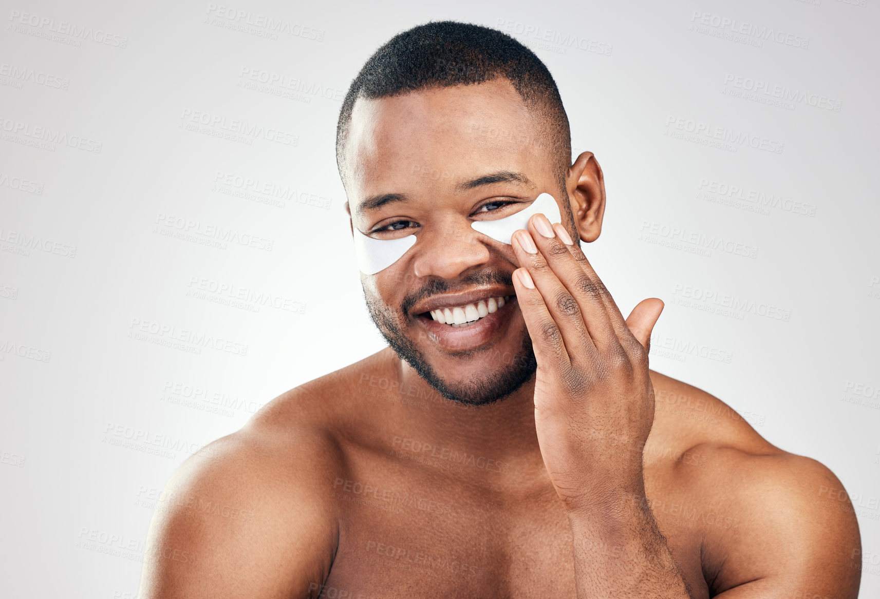 Buy stock photo Studio portrait of a handsome young man wearing under-eye patches against a white background