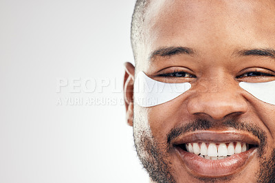 Buy stock photo Studio portrait of a handsome young man wearing under-eye patches against a white background