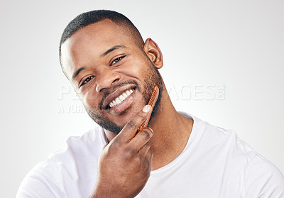 Buy stock photo Studio, comb and beard of black man in portrait for barber, haircare and beauty with smile. Face, Male model and accessories for self care, growth maintenance and grooming by white background