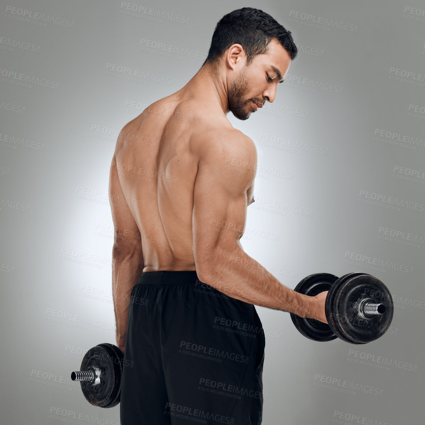 Buy stock photo Man, studio and dumbell for weight lifting or motivation, training or workout for sport. Male athlete, white background and energy with bicep curls in gym for goals, fitness or exercise for health