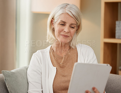 Buy stock photo Senior woman, tablet and sofa for reading in house with technology, smile for news on social media. Search, ebook or living room for research on retirement home with care service, online for wellness